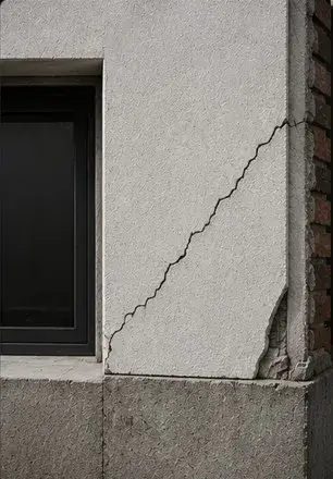 Diagonal crack running from a window corner